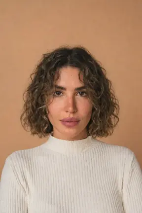Long curls cut to a jaw-length curly bob restyled