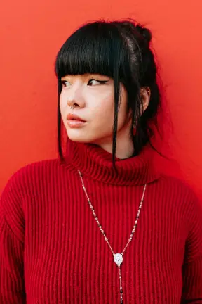 Pinned-up hair with blunt bangs to long caramel waves